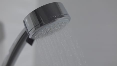 shower head in bathroom with water drops flowing. water drops in the shower head