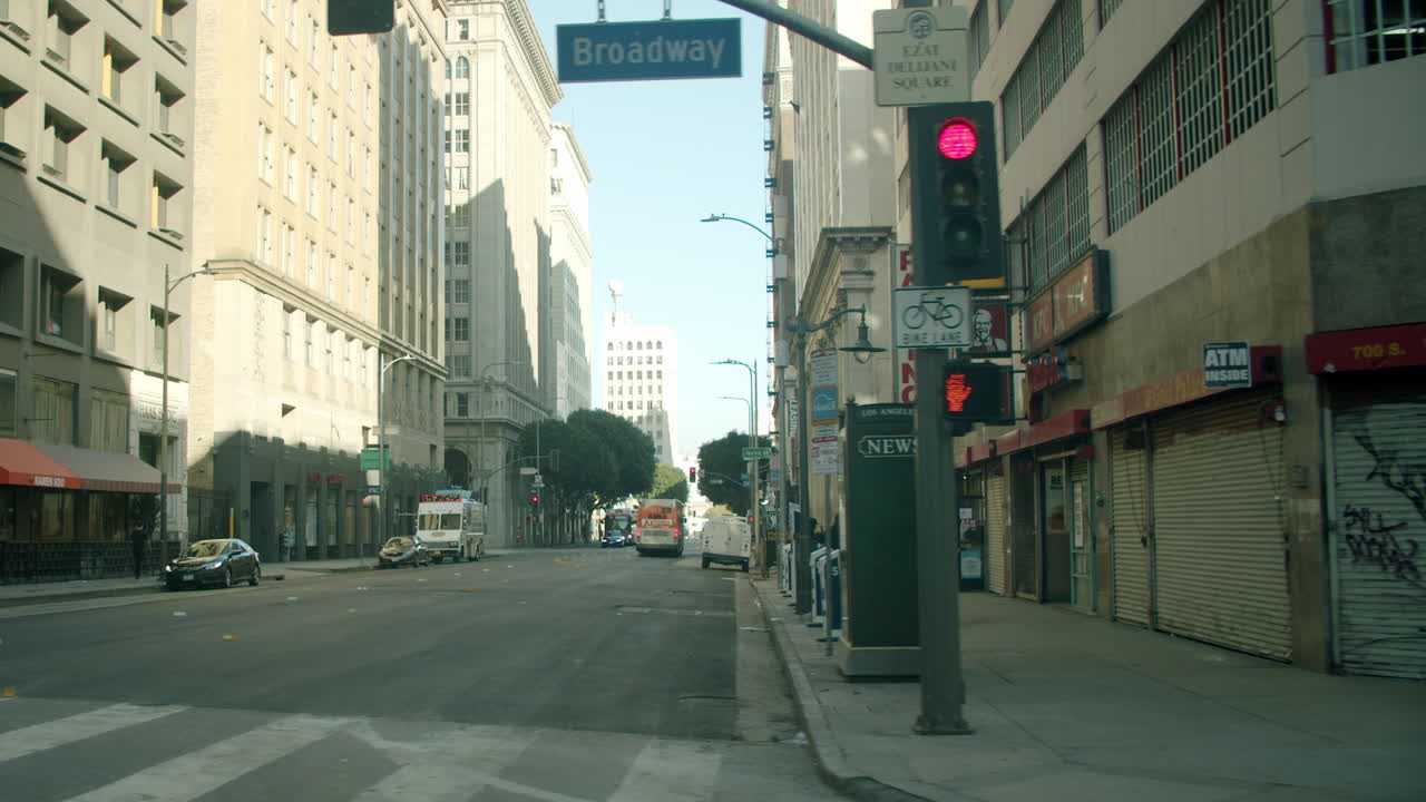 View down a city street lined with tall buildings and businesses