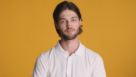 caucasian man in front of camera on yellow background.