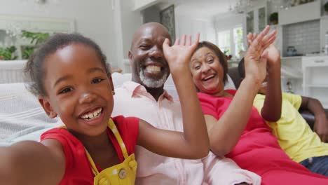 Happy-african-american-grandparents-and-grandchildren-sitting-on-sofa,-having-video-call