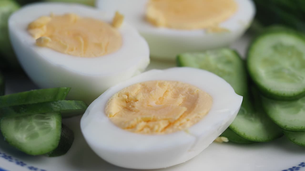 Hard-boiled eggs and sliced cucumbers on a plate
