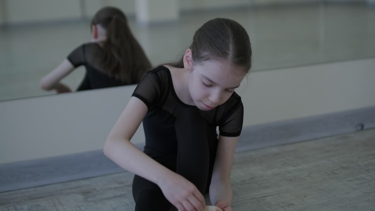 Young Ballerina Practicing Dance Moves in Studio
