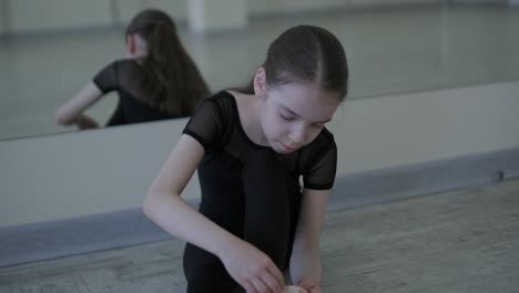young ballerina practicing dance moves in studio