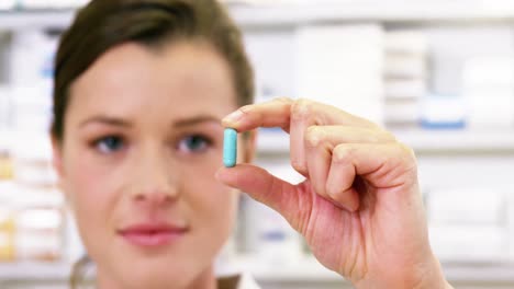 pharmacist checking a capsule