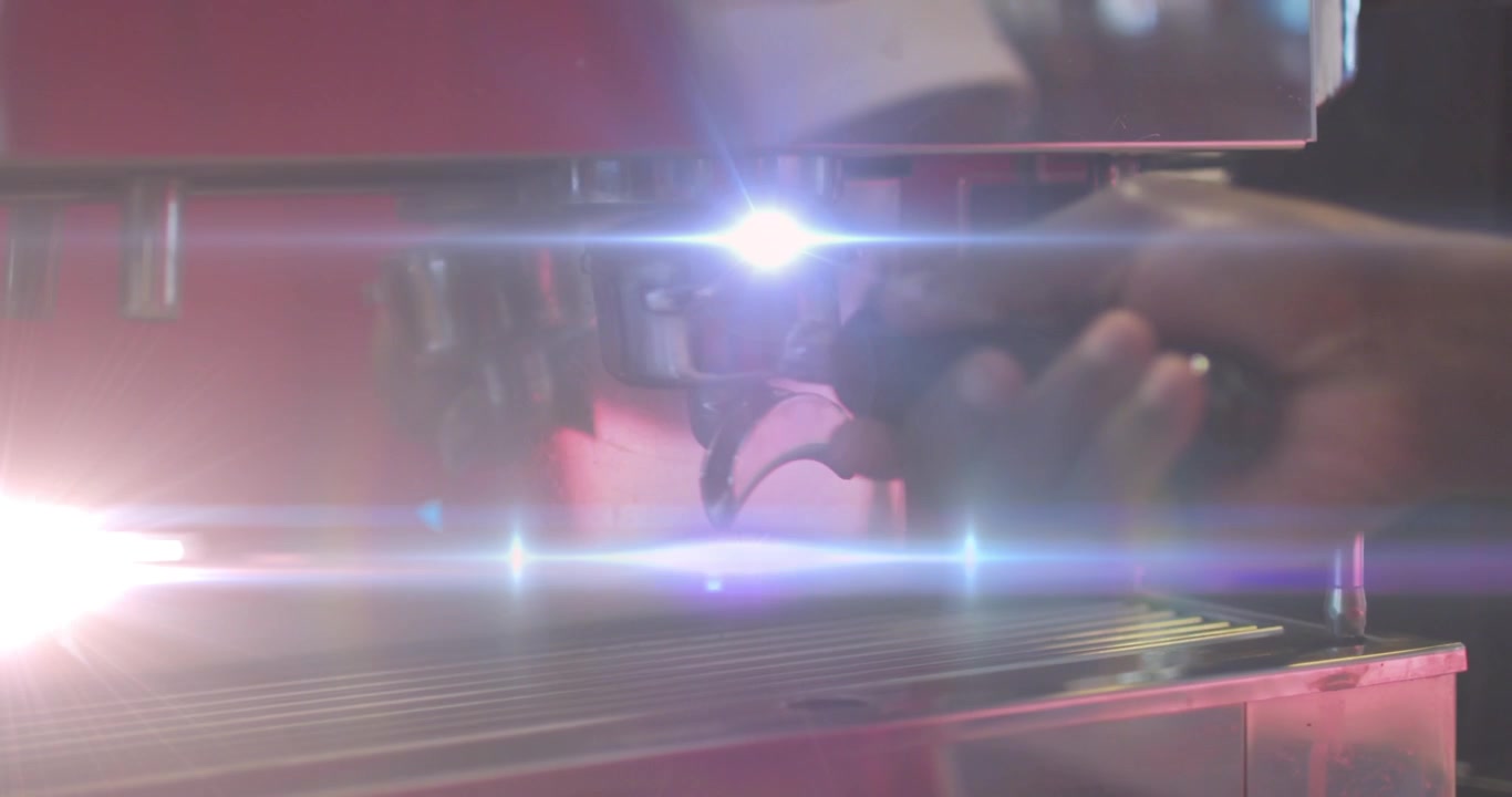 Animation of light spots over man using coffee machine