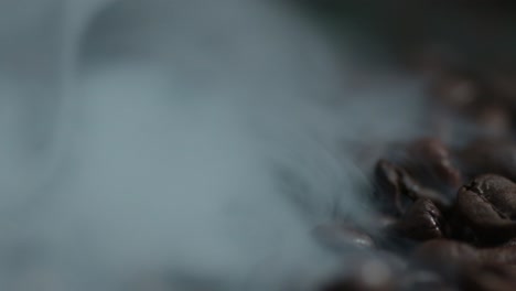 macro of a smoke rises above the coffee bean