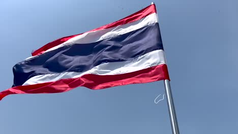 Flag-of-Thailand-blowing-in-the-wind---blue-sky-background