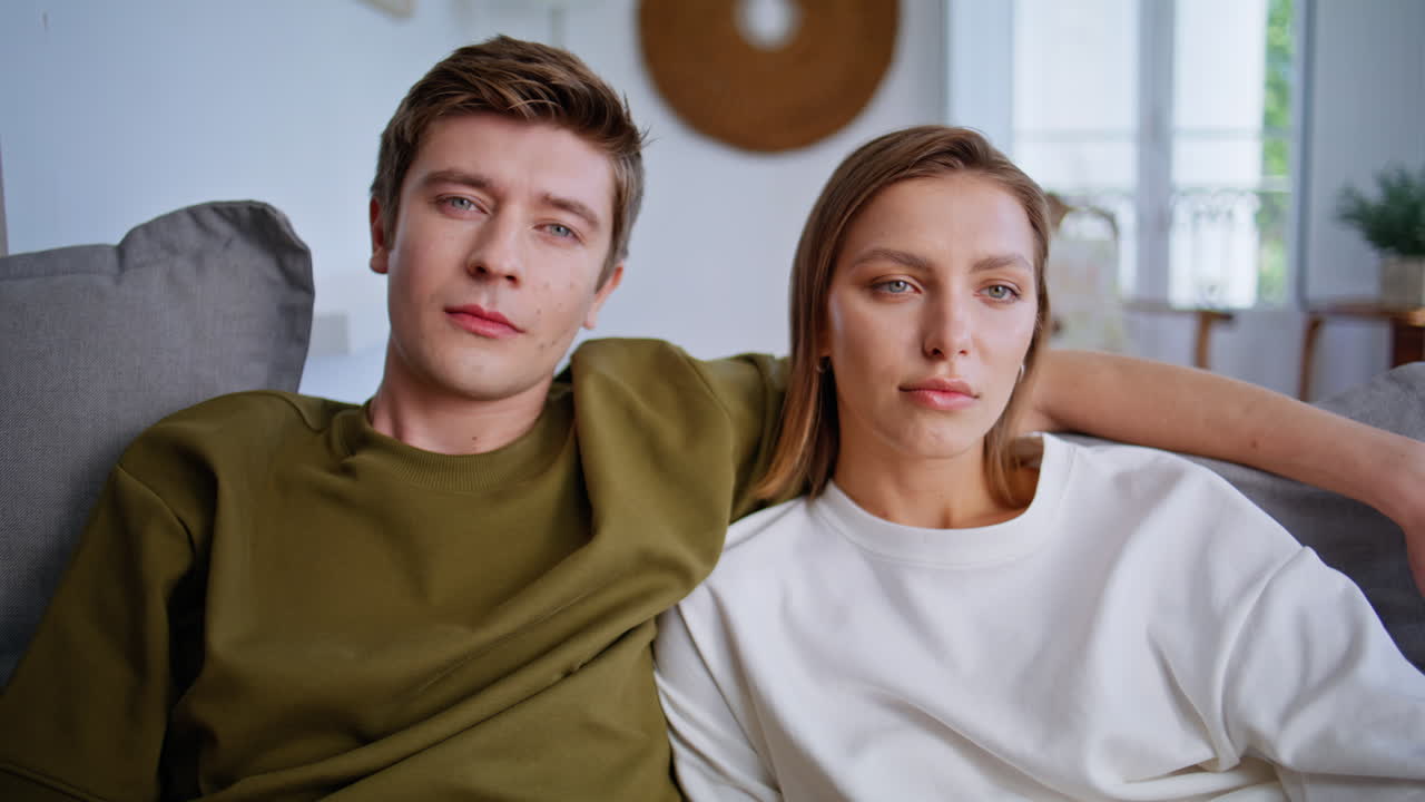 Hugging pair watching movie during home weekend closeup. Man switching channels