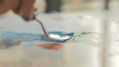 artist mixing acrylic paint using palette knife. real-time