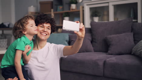 happy mother and son taking a selfie at home