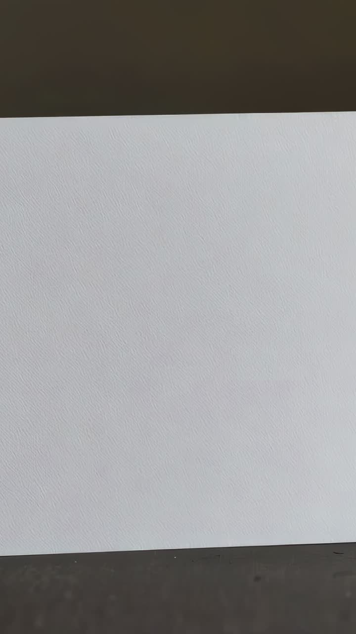 Vertical video: Recording, camera capturing big white panel filling room center, dark bands, specks