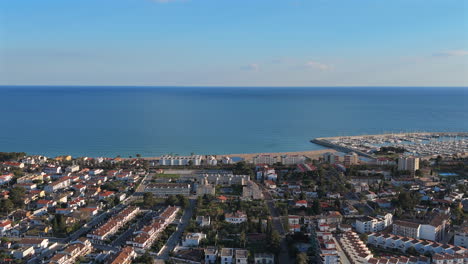 aerial shot of costa dorada with golden beaches, turquoise sea, and a vibrant marina. a breathtaking lateral tracking shot captures the mediterranean coast in stunning 4k detail