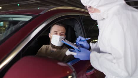 video of man during coronavirus drive-thru pcr test procedure