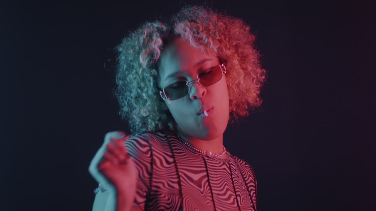 Stylish Woman Eating Lollipop in Neon Light
