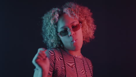 stylish woman eating lollipop in neon light
