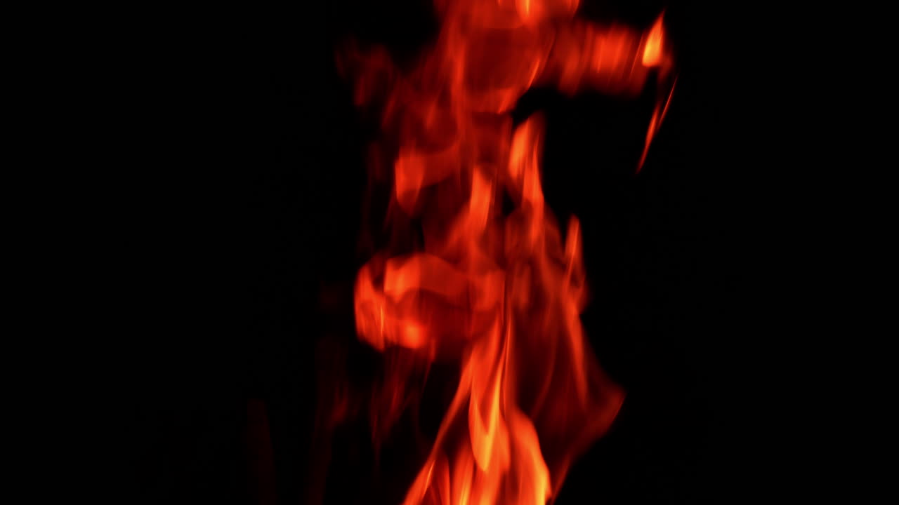 Fire flames burning and going up. Close up. Black backdrop.