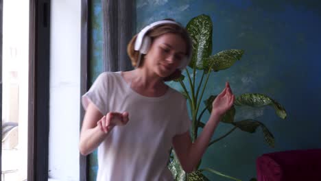 girl dancing while listening music in headphones