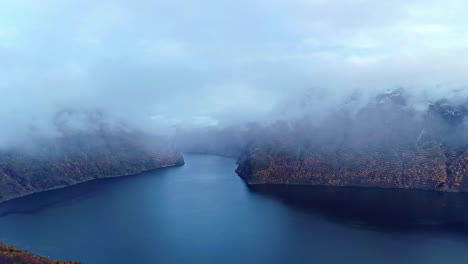 magical fjord in norway covered in fog, aerial drone view