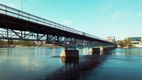 white volkswagen van cruises scenic bridge showcasing sunny skellefteå sweden nordic landscapes scandinavian architecture road trip vibes travel journey adventure exploration vacation tourism vehicle