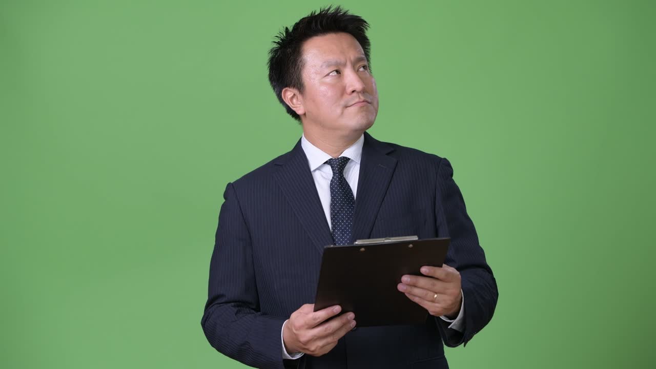 以绿色为背景的成熟日本男商人