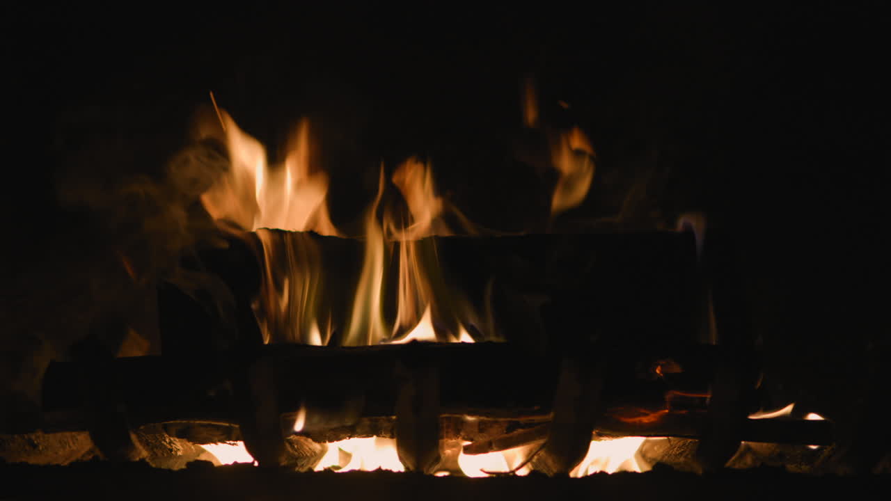 Fireplace Closeup with Medium Size Flames Burning in Dark Room