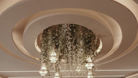 floral wedding chandelier installation with cascading greenery hanging from circular ceiling design