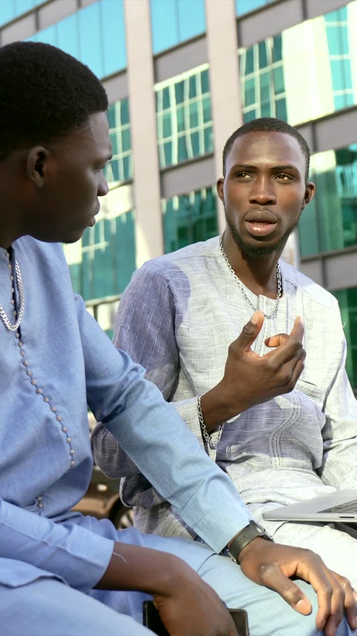 Men in business attire discussing work outdoors