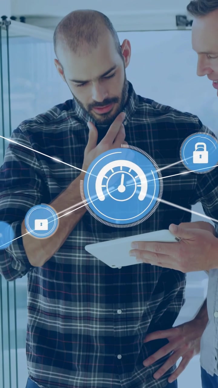 Vertical video: Tilting tablet, plaid man leaning and gesturing, UI gauges forming locks, tech demo