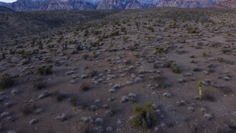 Aerial-shot-revealing-snow-covered-Red-Rock-Canyon-from-the-desert-nearby