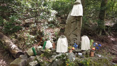 japanese shrine for dead spirits in the forest shinto religion adorned stones, kyoto altar in the forest