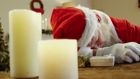 santa claus sleeping at desk