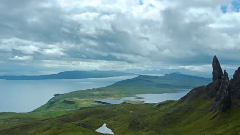 dramatic scenery with towering rock pinnacle in the old man of storr on the isle of skye, scotland. panning shot