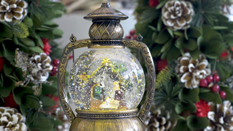 beautiful snowglobe with child in the manger on christmas background