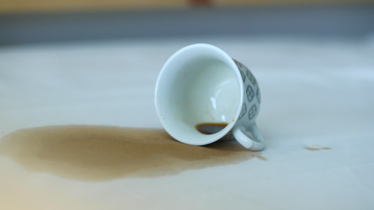 Spilled coffee cup on a white table