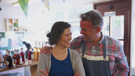 portrait of mature couple running organic farm shop together