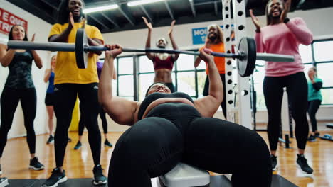 diverse group celebrating a bench press