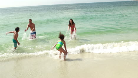 family running toward water