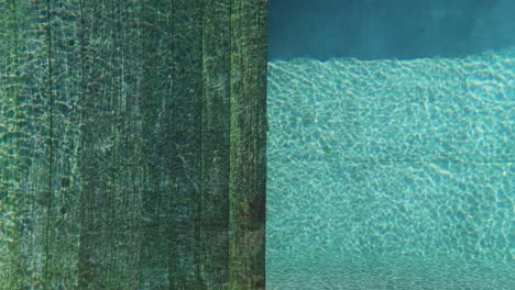 top down aerial view of a swimming pool with stairs going down the turquoise water