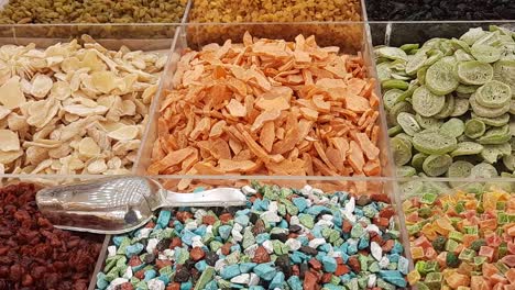 dried fruits and nuts store in dubai gold souk, very colorful and well organized into square containers, slowly tilting upwards video clip