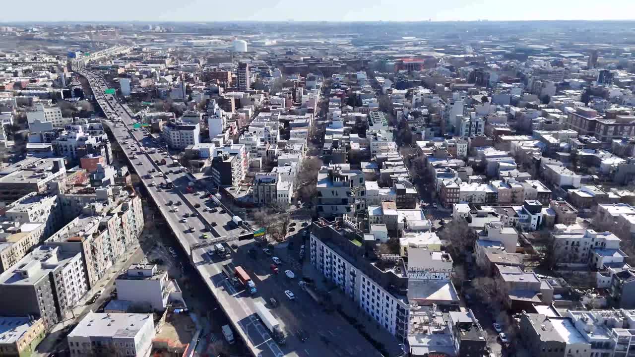 Horizontal drone panoramic shot over Withers Street in Brooklyn, capturing the city's expansive skyline, historic architecture, and vibrant urban landscape with a wide aerial view.