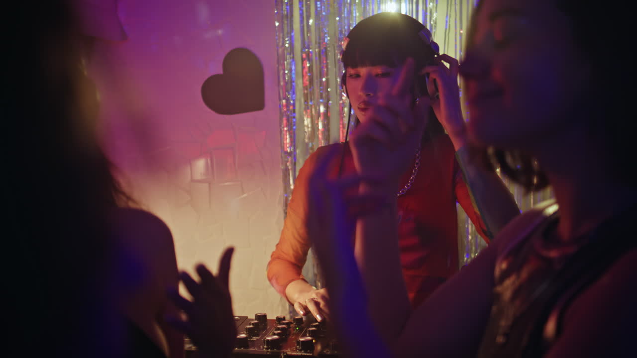 Dj enjoy club atmosphere playing rhythmic music in nightclub lights. woman