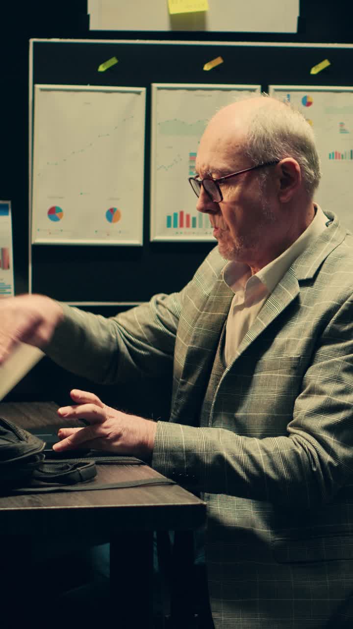 Vertical Video Private inspector opening laptop to cross examine forensic evidence