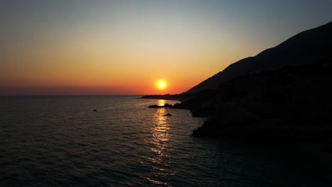 romantic sunset on ionian sea beaches where cliffs silhouette and bay reflect the last rays of sunlight