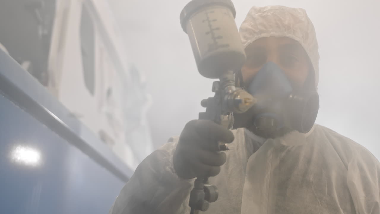 Workman Spraying Paint on Camera