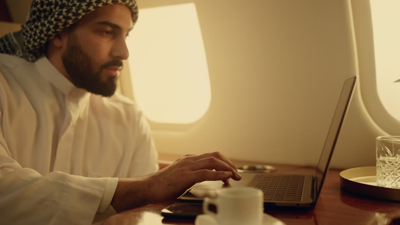 Confident leader browsing laptop on trip closeup. Focused arabian businessman