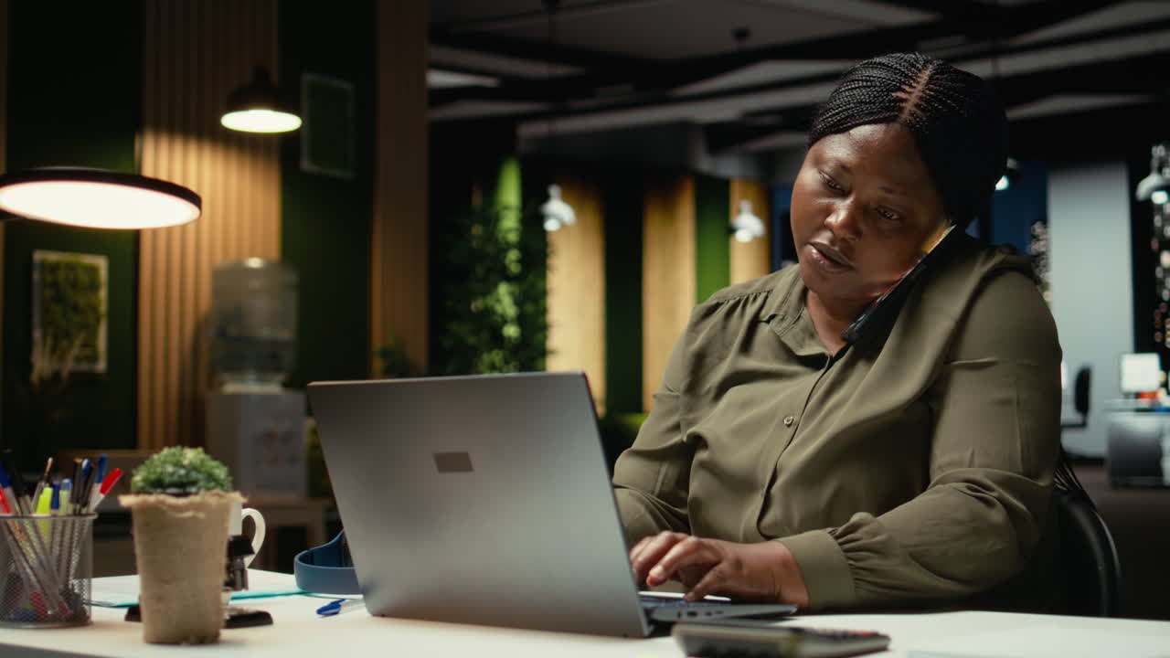 Businesswoman answering phone call for a remote discussion with associate
