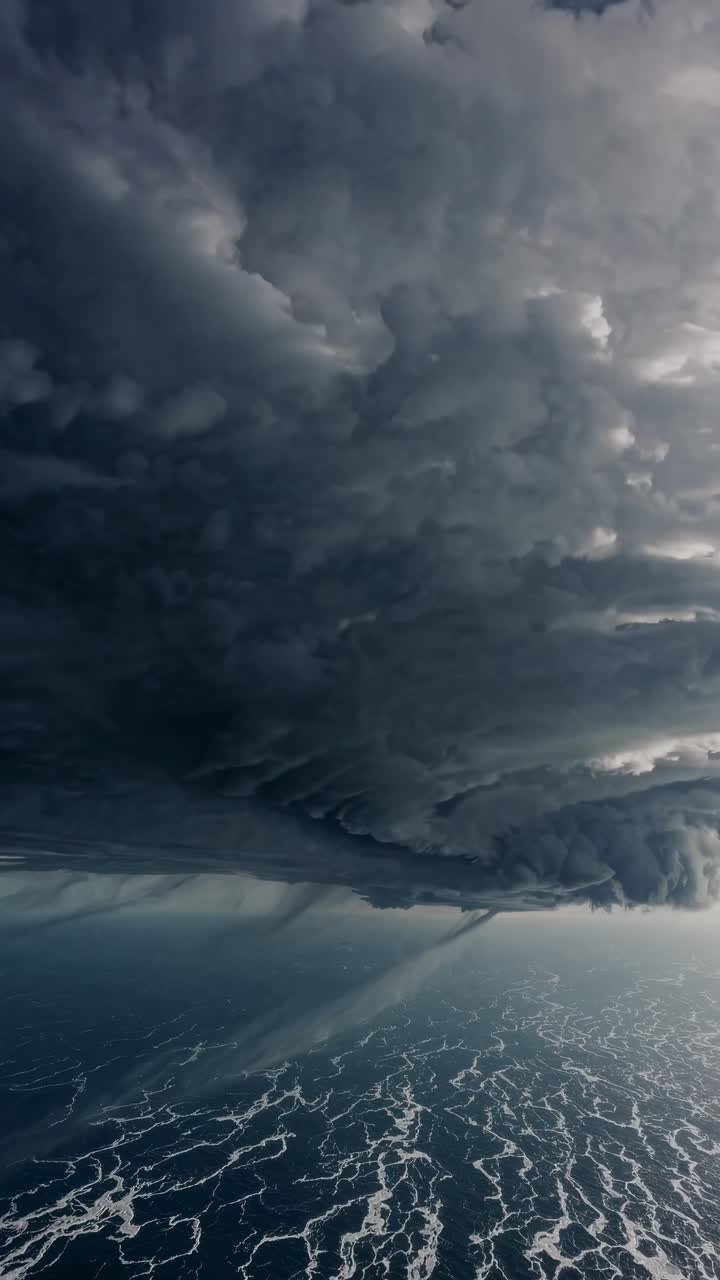 Dramatic aerial video angle captures a swirling storm cloud over a turbulent sea