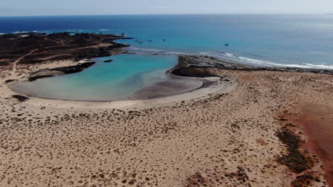 Aerial-orbit-shot-of-La-Concha-beach-on-Lobos-Island