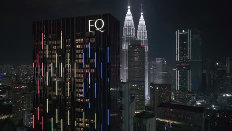 aerial view rising in front of the eq luxury hotel, night in kuala lumpur, malaysia