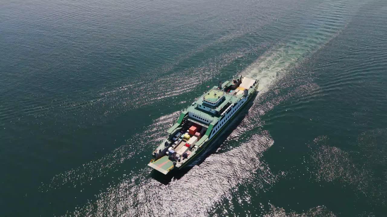 Orbiting drone shot of a Ro-Ro ship approaching Labuan Island port, Malaysia